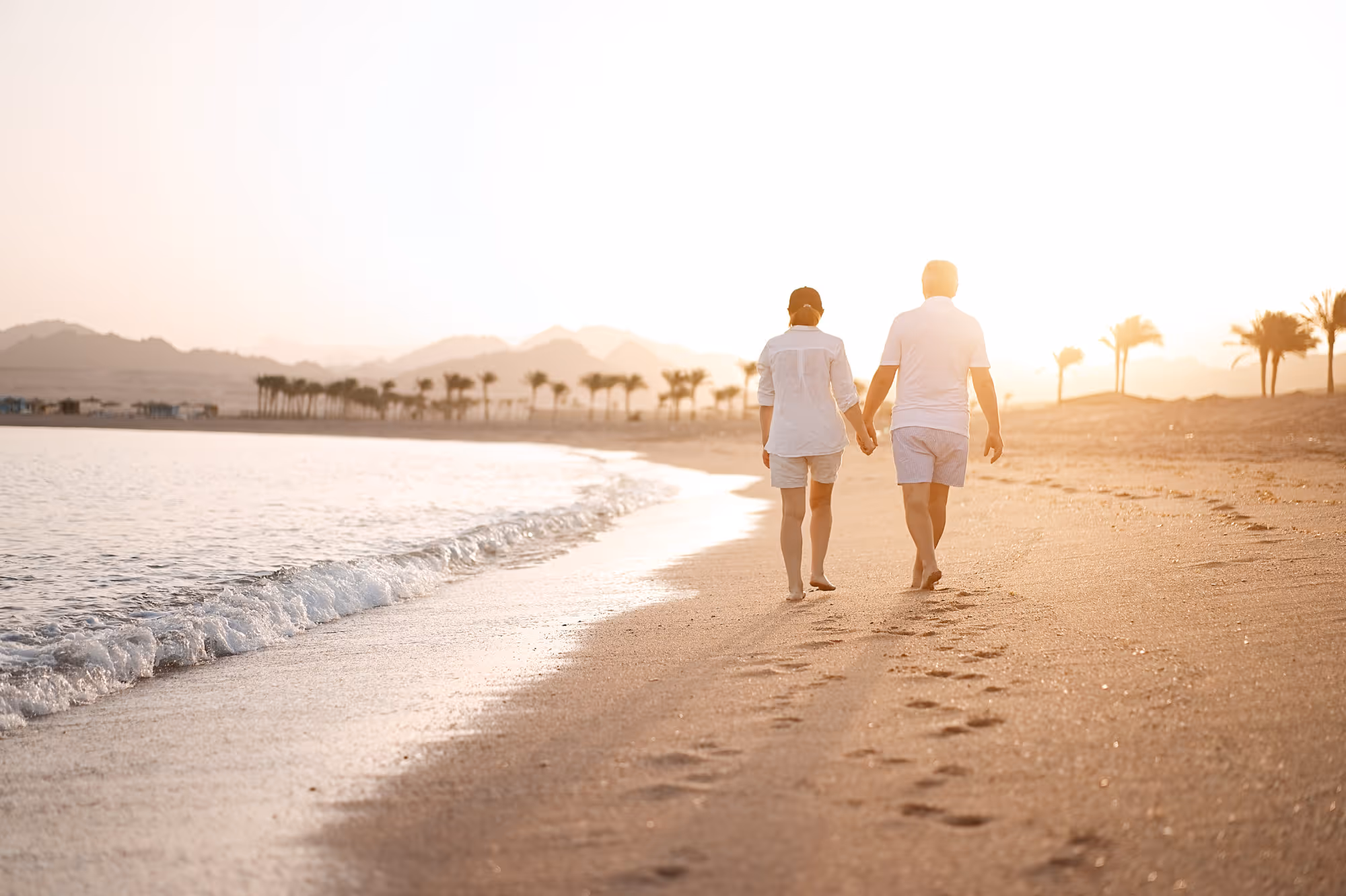 Happy family walking on Sayulita beach, representing recovery and improved quality of life through regenerative medicine and stem cell therapy in Mexico.